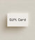White gift card with 'Gift Card' text on a beige background