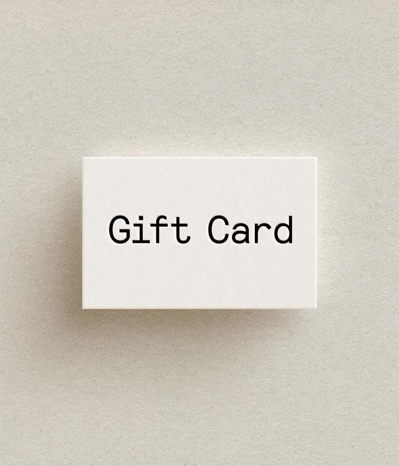 White gift card with 'Gift Card' text on a beige background